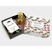 Gift set with a small figurine and decorative box labeled 'Lily & Me' on a white background.