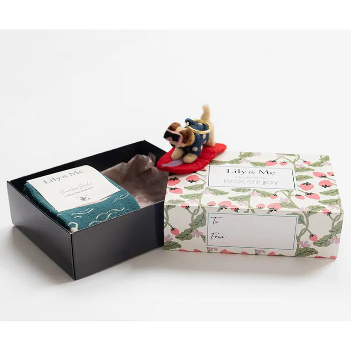 Gift set with a plush toy and card in a decorative box on a white background