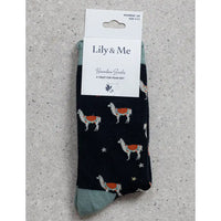 Packaged socks with llama design on a gray surface, featuring 'Lily & Me' branding.