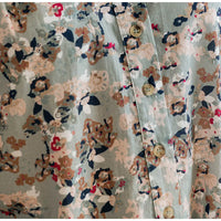 Floral patterned fabric with buttons on a light blue background