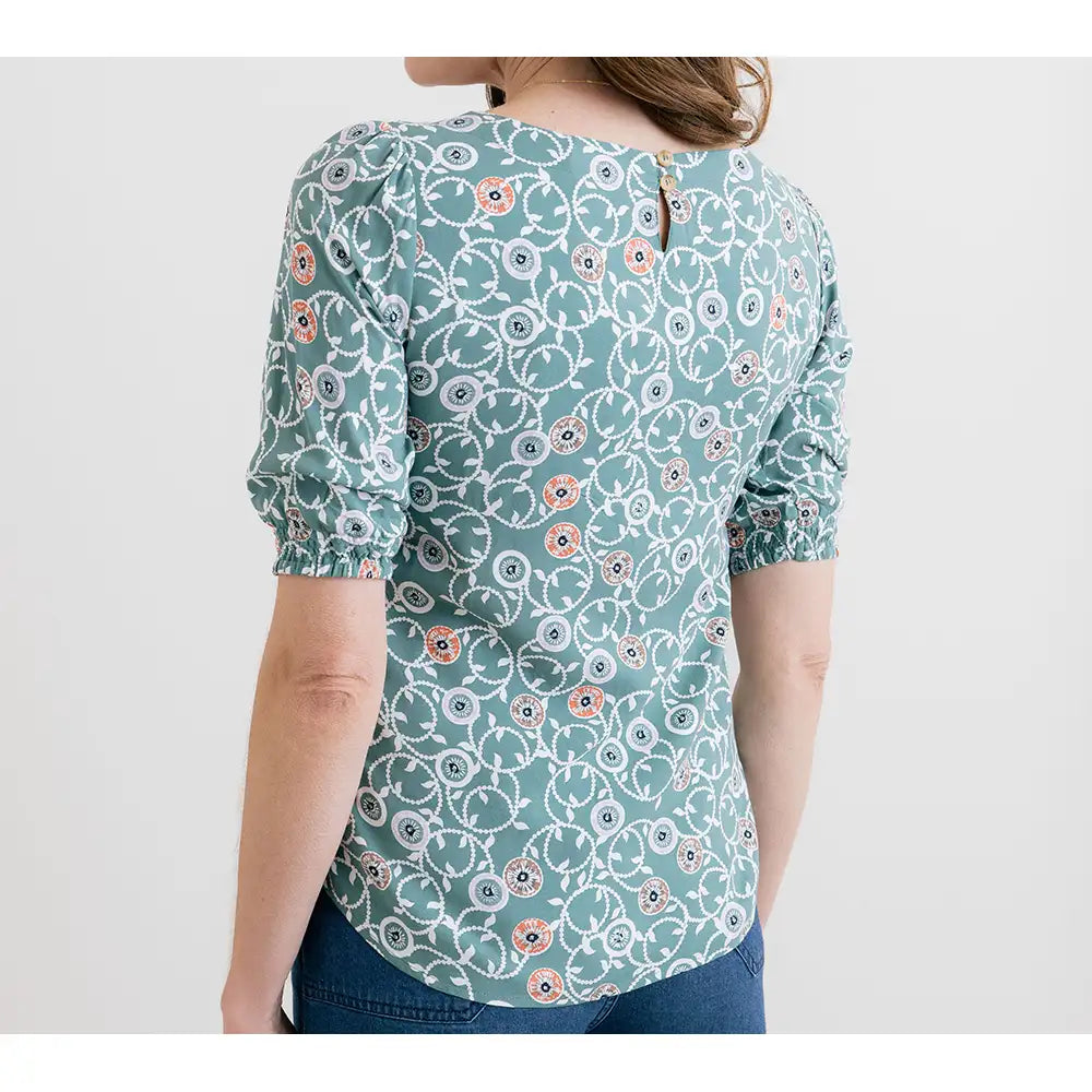 Woman wearing a floral patterned blouse on a white background