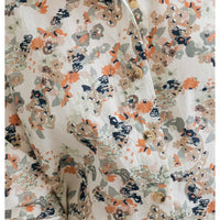 Ecru base with a delicate floral pattern on it. 