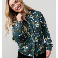 Woman wearing a floral patterned jacket on a plain background