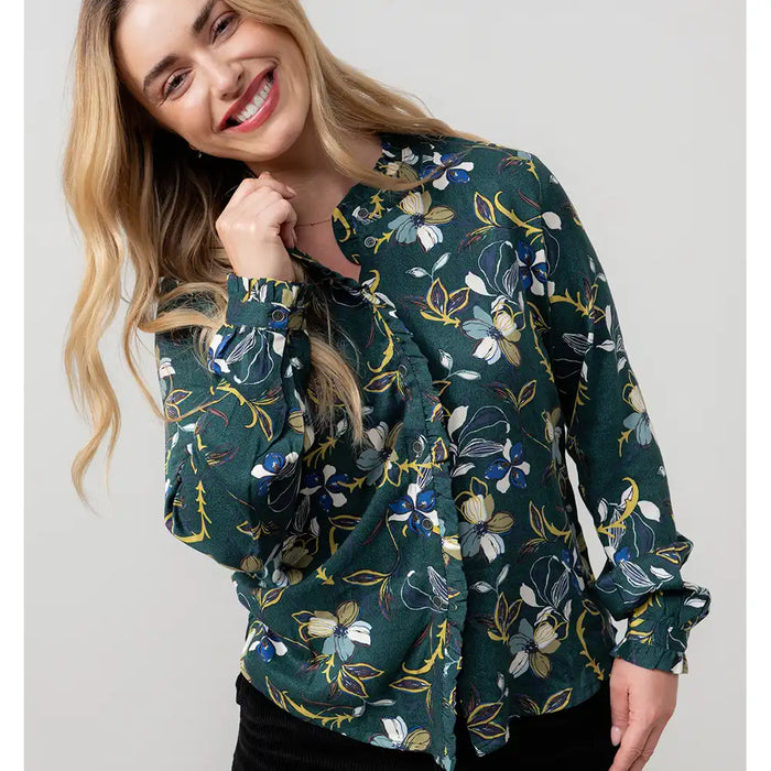 Woman wearing a floral patterned jacket on a plain background