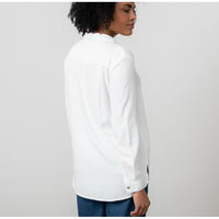 Person wearing a white shirt with a plain background