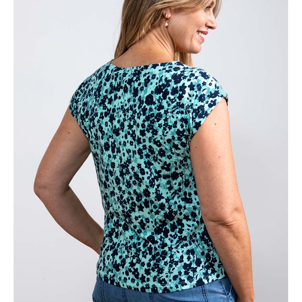 Back a sea green top with short sleeves and paler sea green and navy blue clusters on 