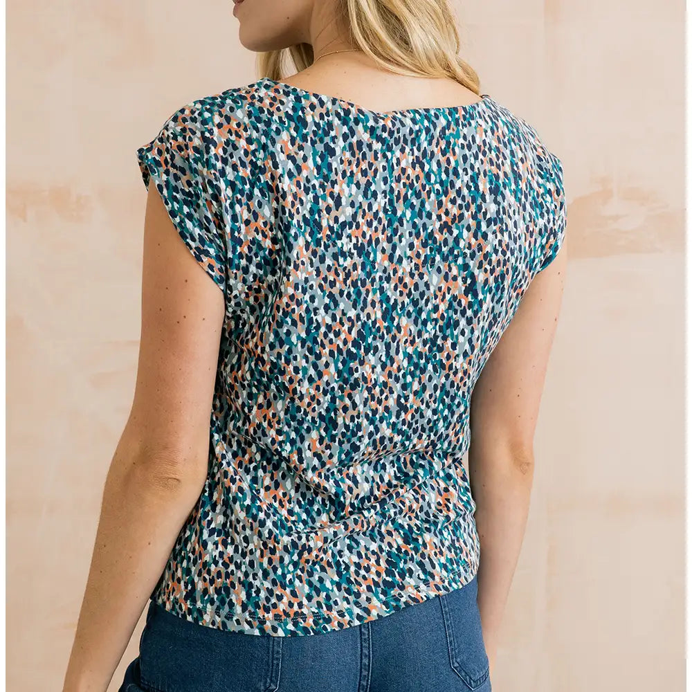 Blue dappled top with short sleeves and hints of orange in it.