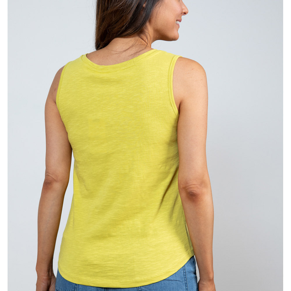 Female with short brunette hair wearing a  bright yellow lime vest top with wide shoulder straps and a high round neckline at the nape of the neck