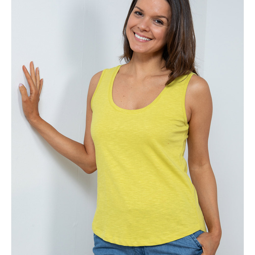 Female with short brunette hair wearing a bright yellow lime vest with wide shoulder straps and a round necklinee