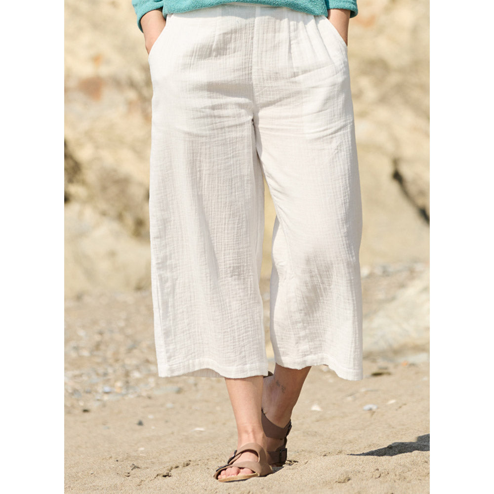 White cropped length wide leg textured trousers with pockets at the hips