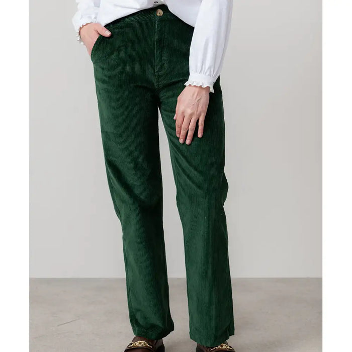Front of straight of leg cord trousers in green with pocket and beige button.