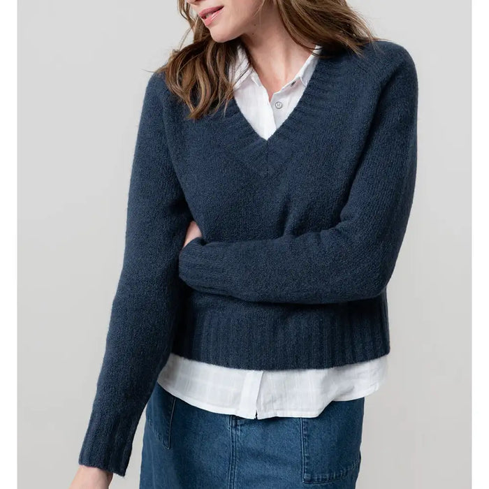 Front of navy blue v neck jumper with long sleeves. 