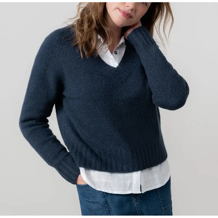Front of navy blue v neck jumper with long sleeves. 