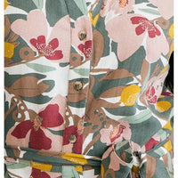 Floral patterned fabric with pink, red, and yellow flowers on a green background.
