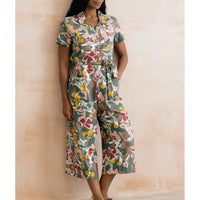 Woman wearing a floral Jumpsuit against a beige background