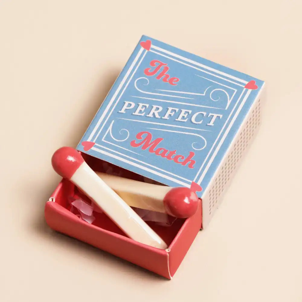 Decorative match stick  ornament in a box with "The Perfect Match"  printed on the box, on a beige background