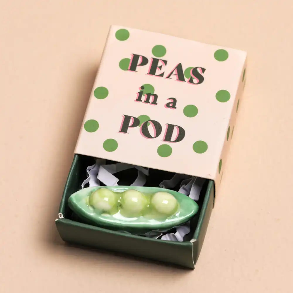 Decorative set of 'Peas in a Pod' with a matching box on a beige background