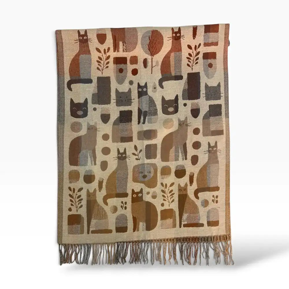A woven scarf with a beige and brown abstract pattern featuring stylized cat silhouettes, fringed ends