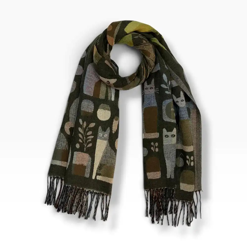 A dark olive green woven scarf with a pattern of stylized cats, plants, and geometric shapes in muted brown, beige, and gray tones, finished with dark fringe, shown on a light gray background.