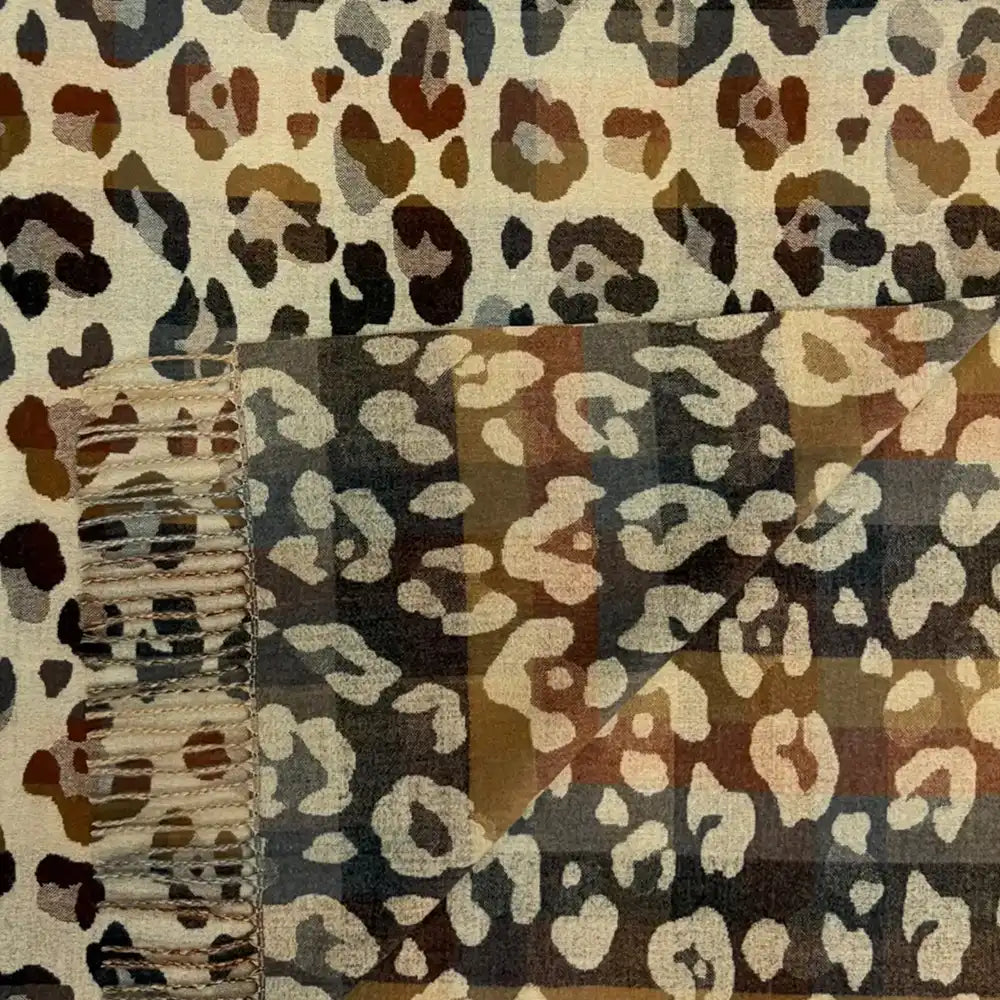 Ecru coloured scarf with tassels. Brown and grey leopard print all over it.