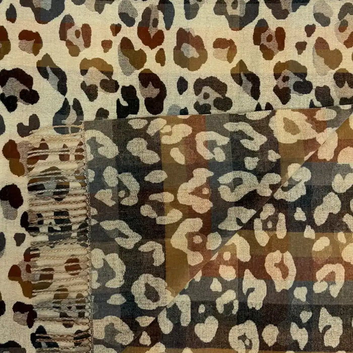 Ecru coloured scarf with tassels. Brown and grey leopard print all over it.