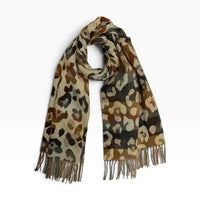Ecru coloured scarf with tassels. Brown and grey leopard print all over it. On a white background
