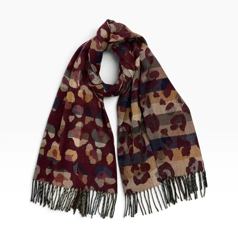 Bungundy coloured scarf with tassels and a bige leopard print all over it. On a white background.