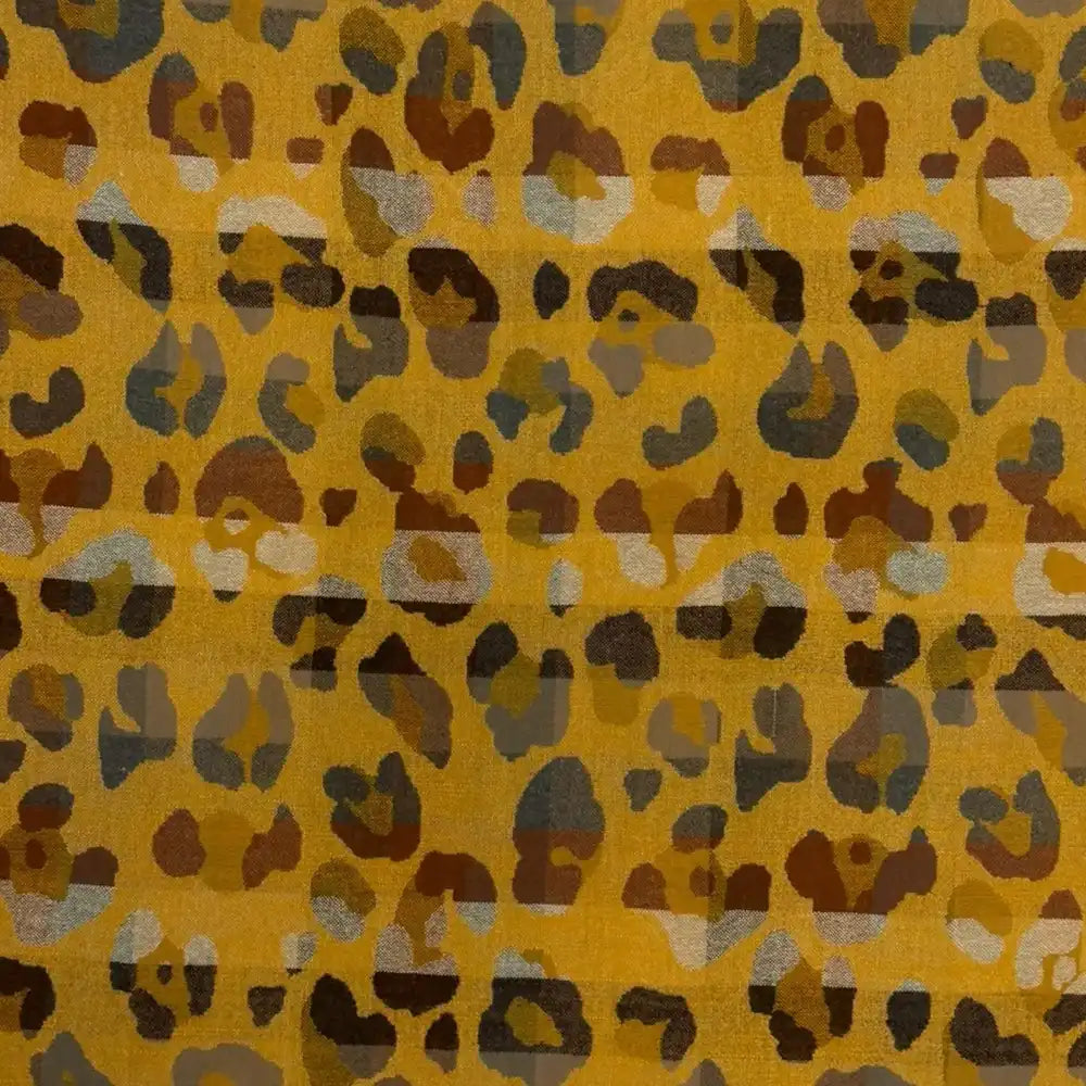 Mustard coloured scarf with tassels. Beige and grey leopard print all over it. 