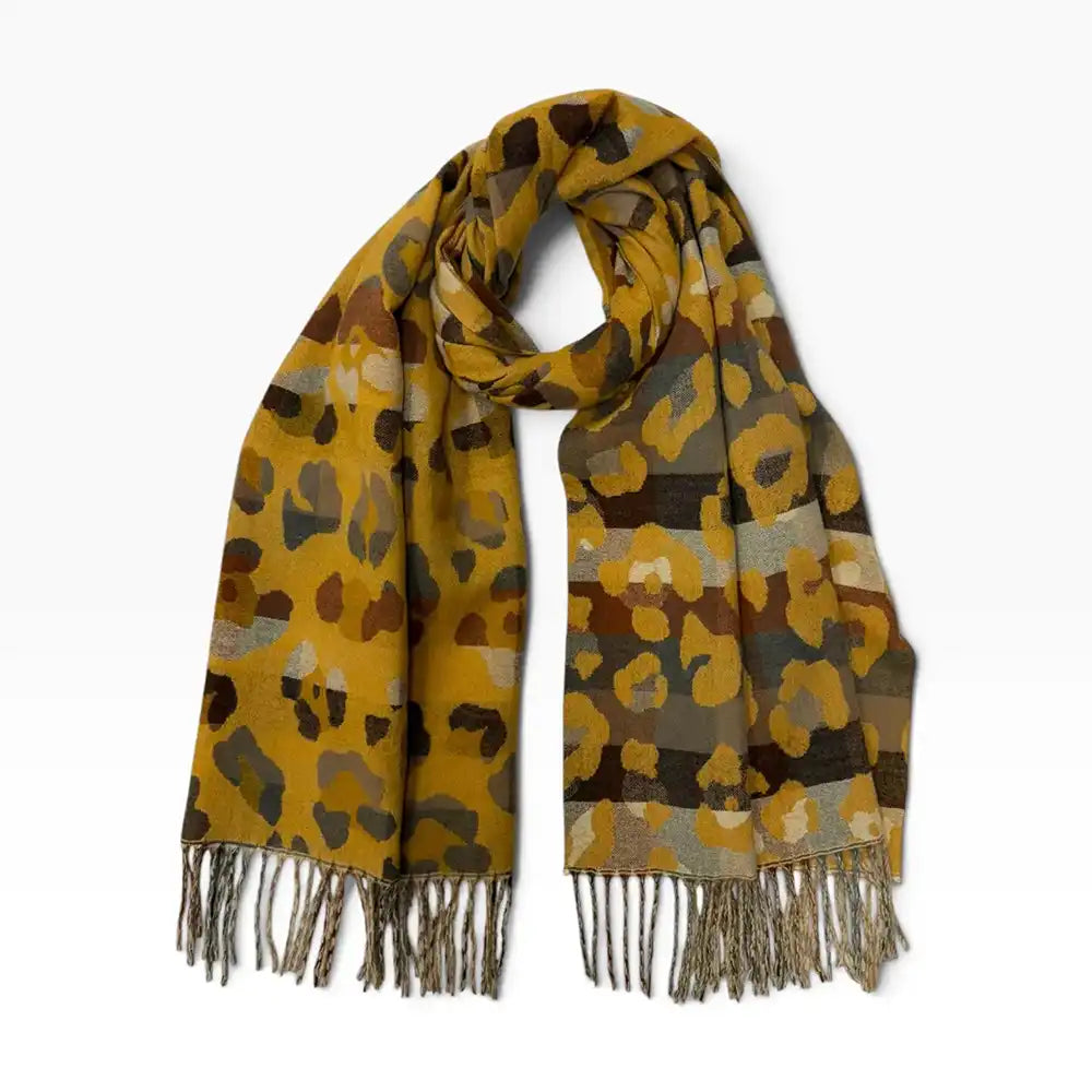 Mustard coloured scarf with tassels. Beige and grey leopard print all over it. On a white background