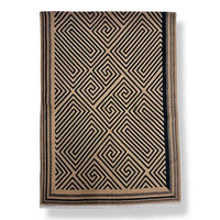 A rectangular scarf with a geometric black and beige Greek key pattern and fringe on the bottom edge, shown against a plain white background.