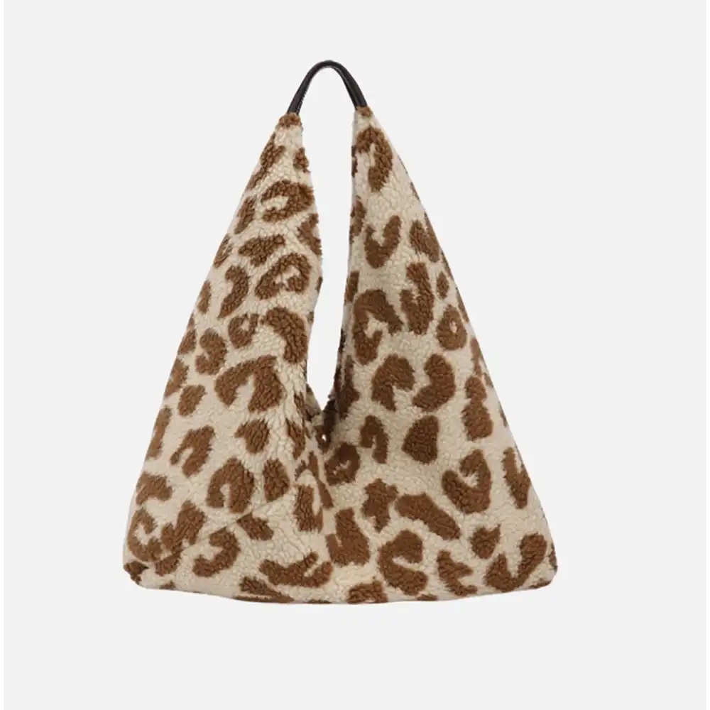 Triangular shaped tote bag with cream base and tan brown feline spots all over. Thin brown handle at the top.