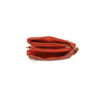 The inside of a small cross-body bag in faux leather on a white background