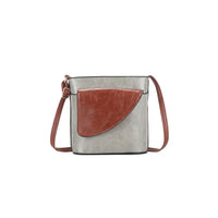 Crossbody bag with grEy body and brown flap on a white background