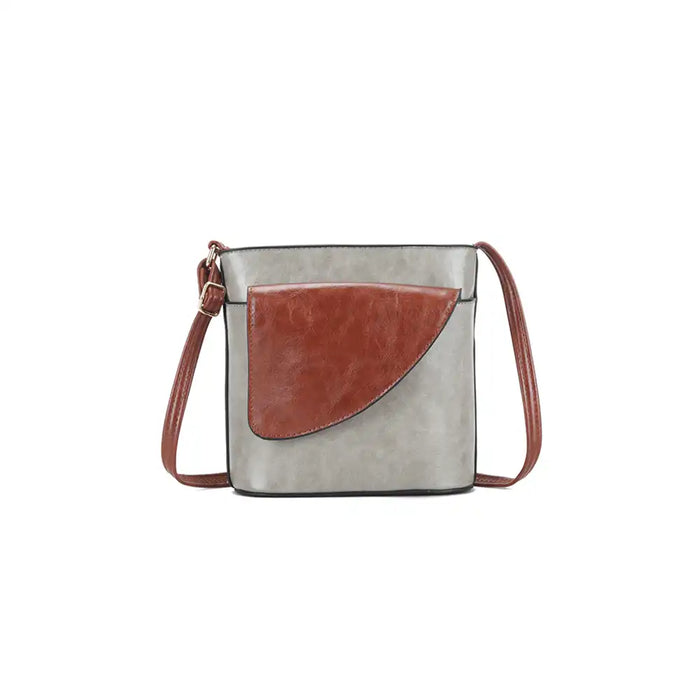Crossbody bag with grEy body and brown flap on a white background