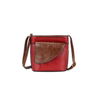 Red and brown faux leather crossbody bag on a white background