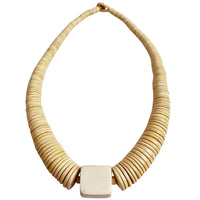 Beige woven necklace with a square pendant on a white background