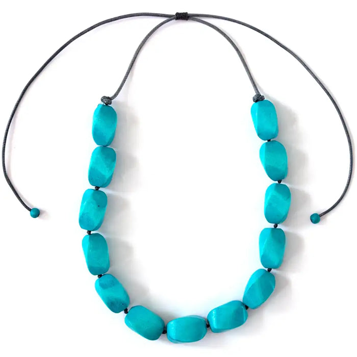 Turquoise necklace with large beads on a white background