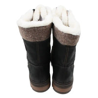 Pair of black winter boots with white fur lining on a white background
