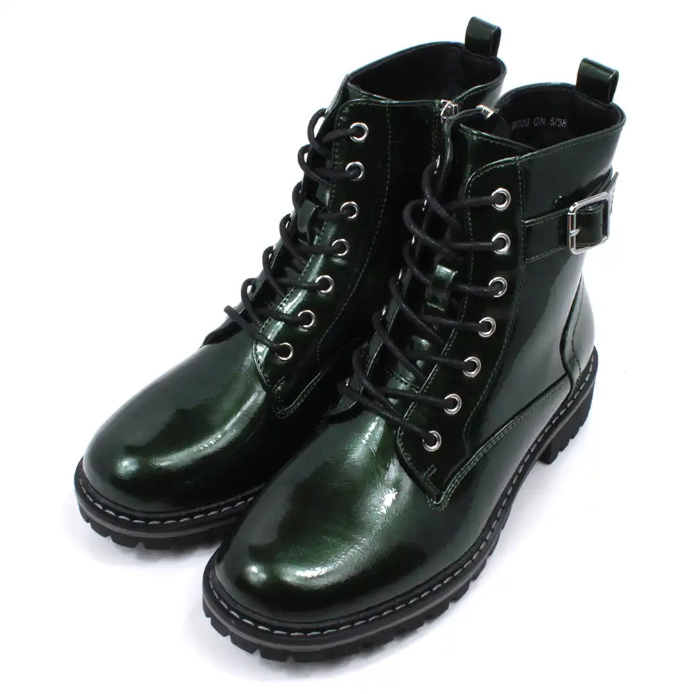 Pair of patent green combat boots with black laces on a white background