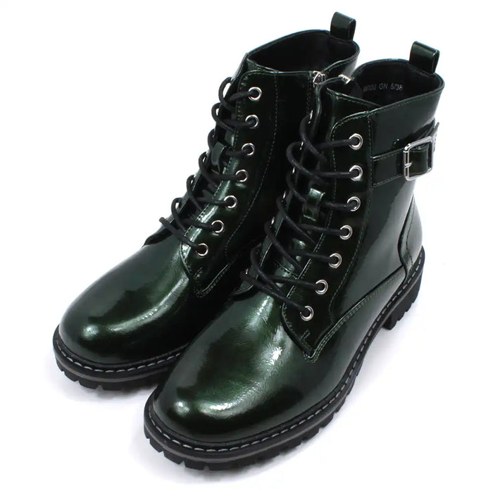 Pair of patent green combat boots with black laces on a white background