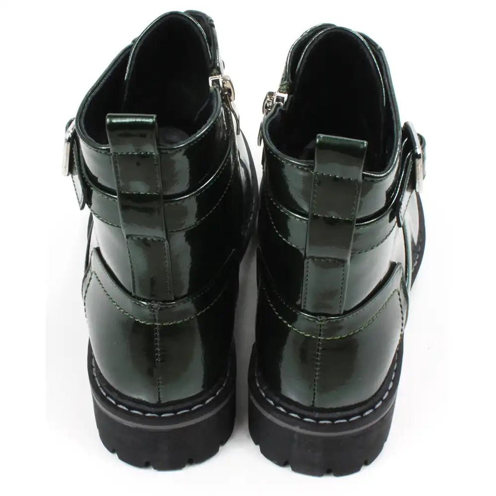 Pair of patent green combat boots with black laces on a white background
