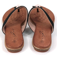 Flat toe post sandals in black with tan coloured textured footbed. Straps in textured fabric and featuring a gemstone centred over the foot. Back view.