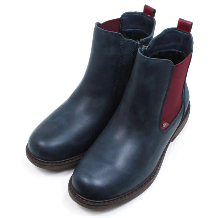 Lunar Suvi Chelsea boots in navy blue. Low heels. Deep red elasticated side panels and ankle tabs. Angled view.