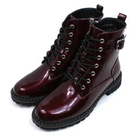 Lunar urban boots in patent burgundy. Front seven eye lacing. Zip up fitting. Black rugged soles. Angled view.