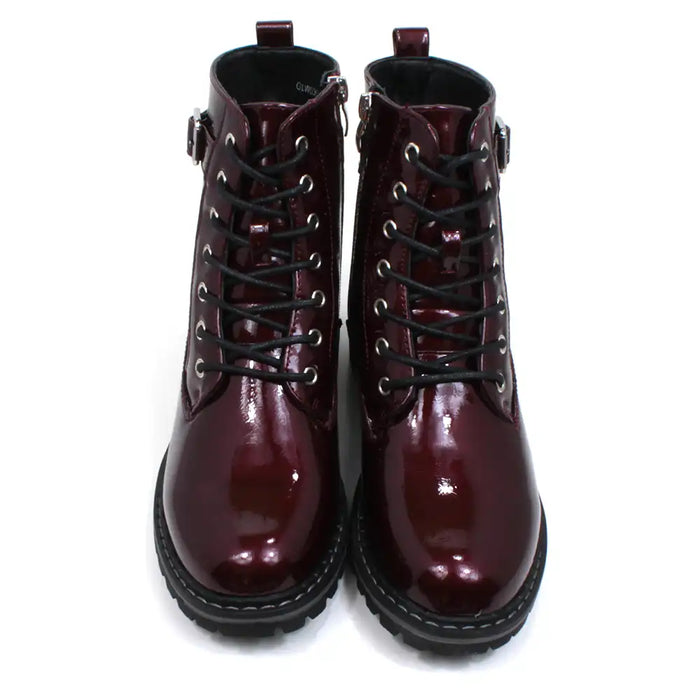 Lunar urban boots in patent burgundy. Front seven eye lacing. Zip up fitting. Black rugged soles. Front view.