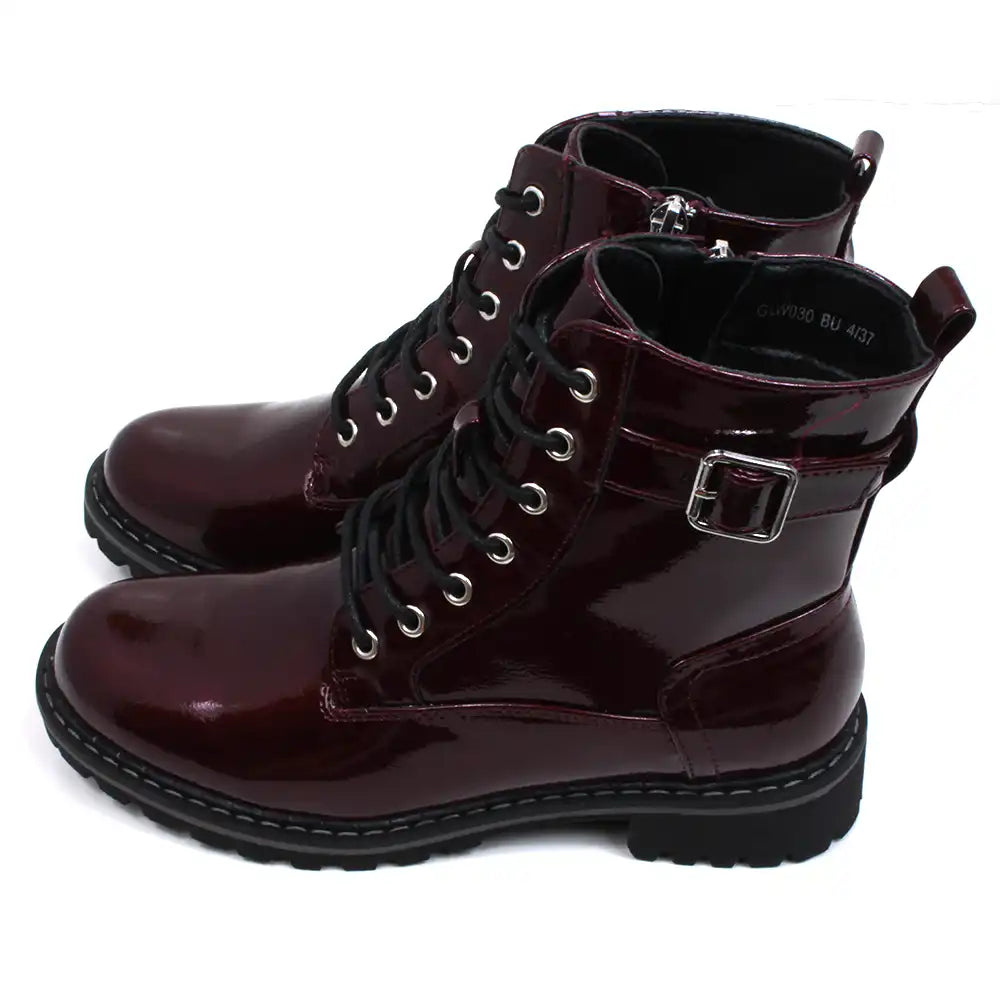 Lunar urban boots in patent burgundy. Front seven eye lacing. Zip up fitting. Black rugged soles. Side view.