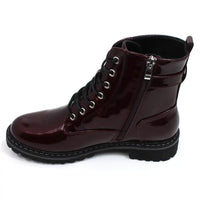 Lunar urban boots in patent burgundy. Front seven eye lacing. Zip up fitting. Black rugged soles. View of single boot showing zip fastening..