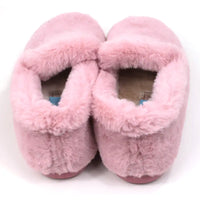 Pair of pink fuzzy slippers on a white background