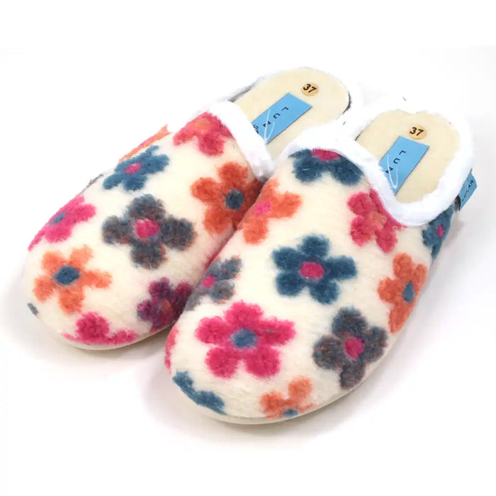 Pair of floral-patterned slippers on a white background