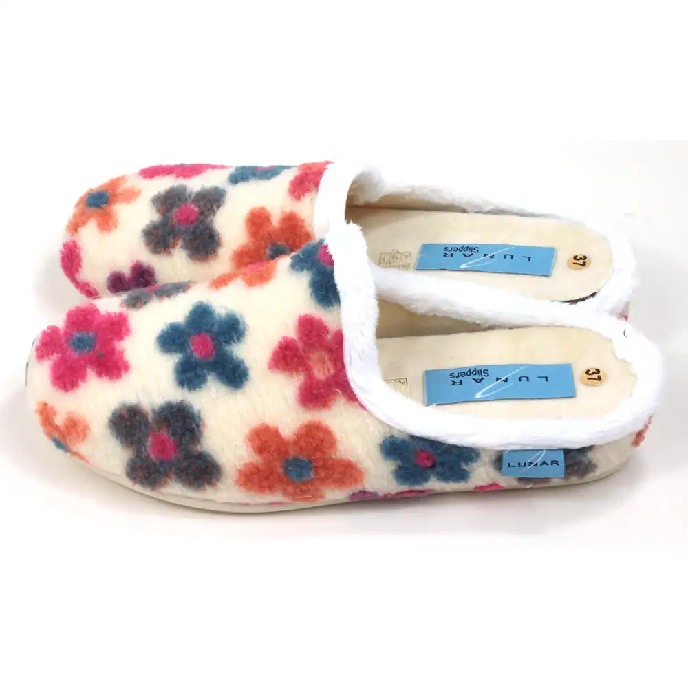 Floral patterned slippers with white trim on a white background